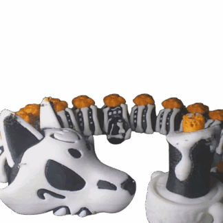 A black and white skeleton dog or wolf figurine with orange accents, coiled in a circle with a skull-like head.